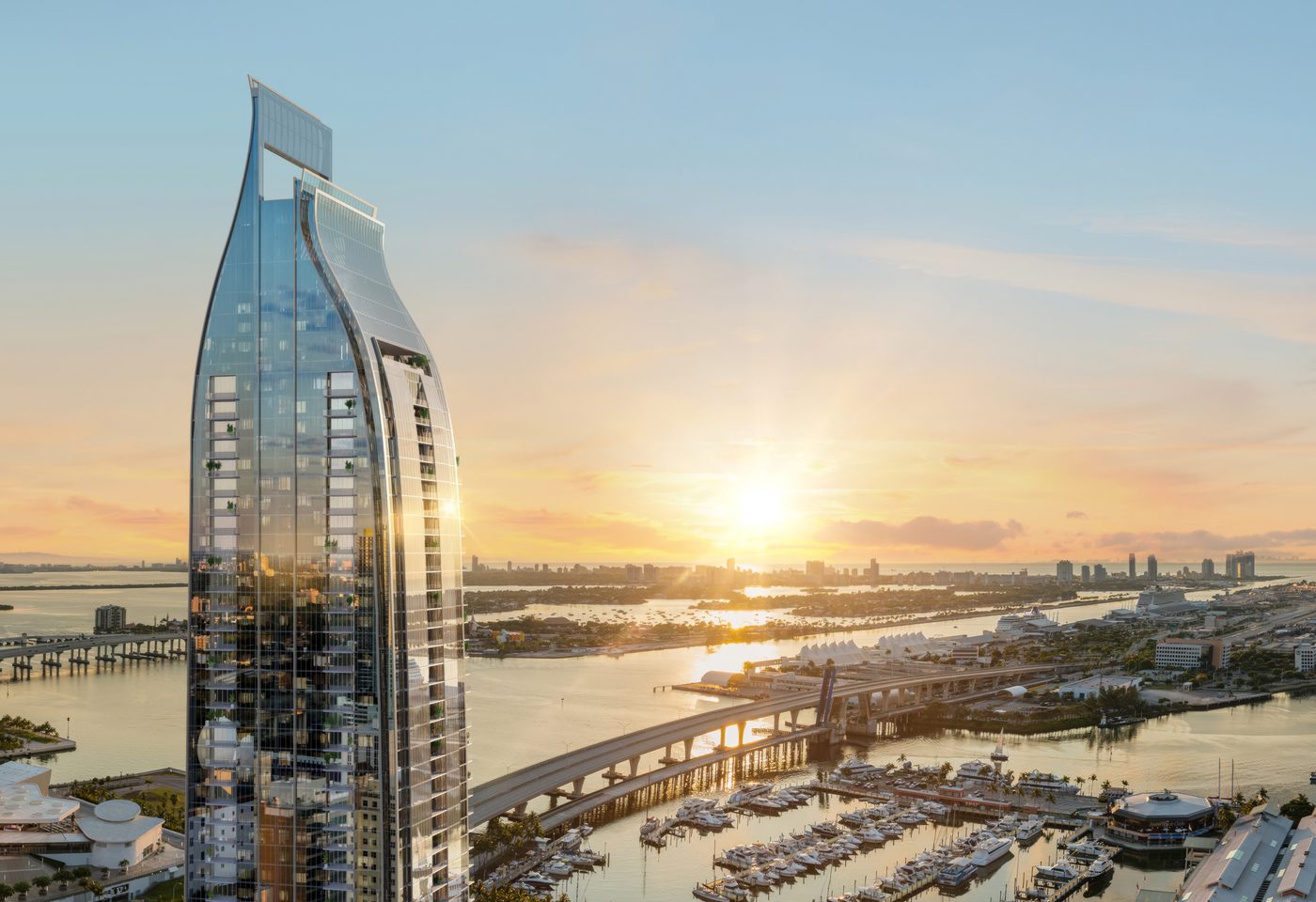 Rendering of Delano Residences and Hotel Miami, a slender glass tower over Biscayne Bay at sunset