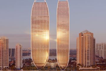 Rendering of the two elliptical St Regis Residences towers at dusk above the beach at Sunny Isles, reflected in the water