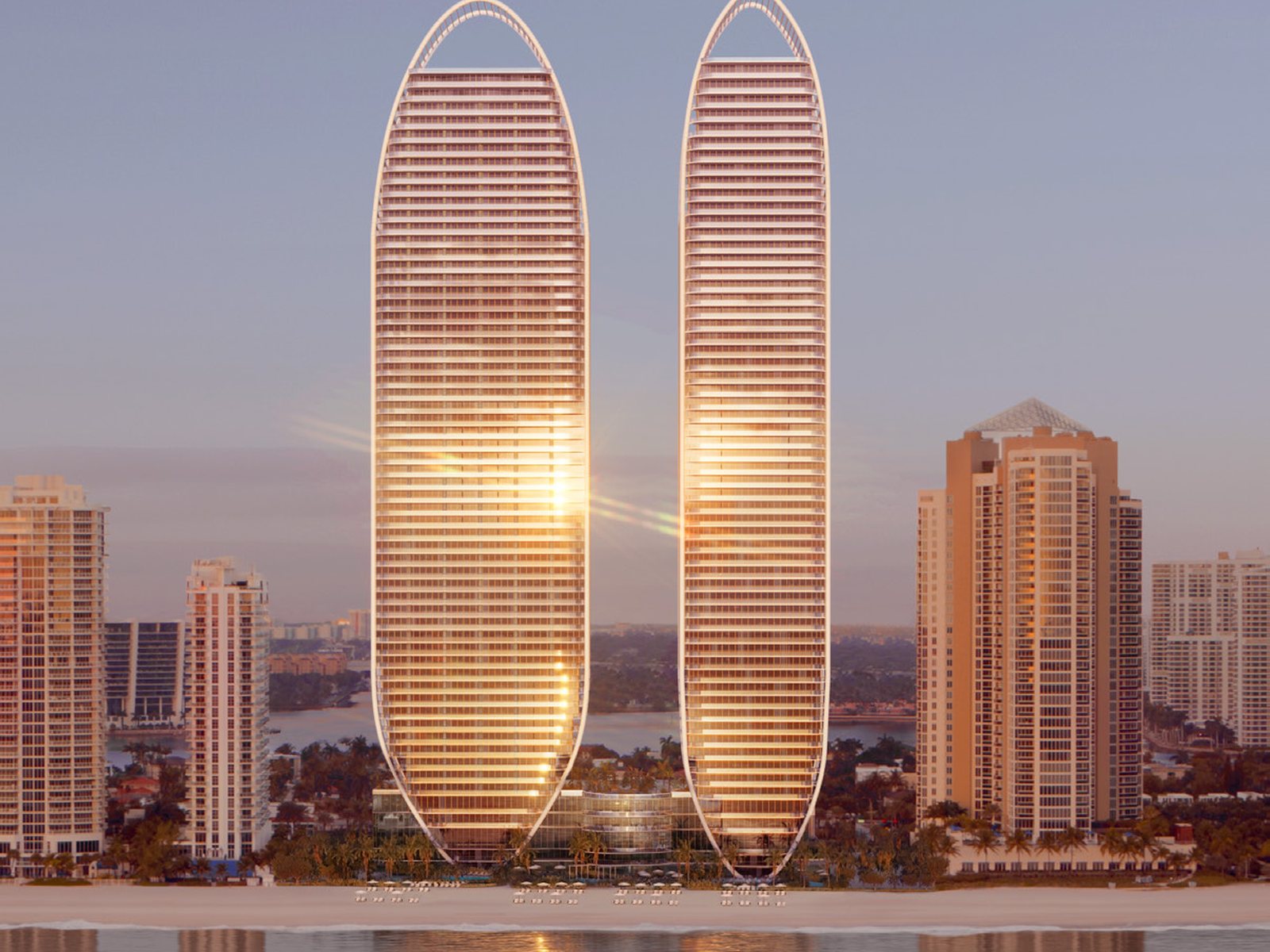 Rendering of the two elliptical St Regis Residences towers at dusk above the beach at Sunny Isles, reflected in the water