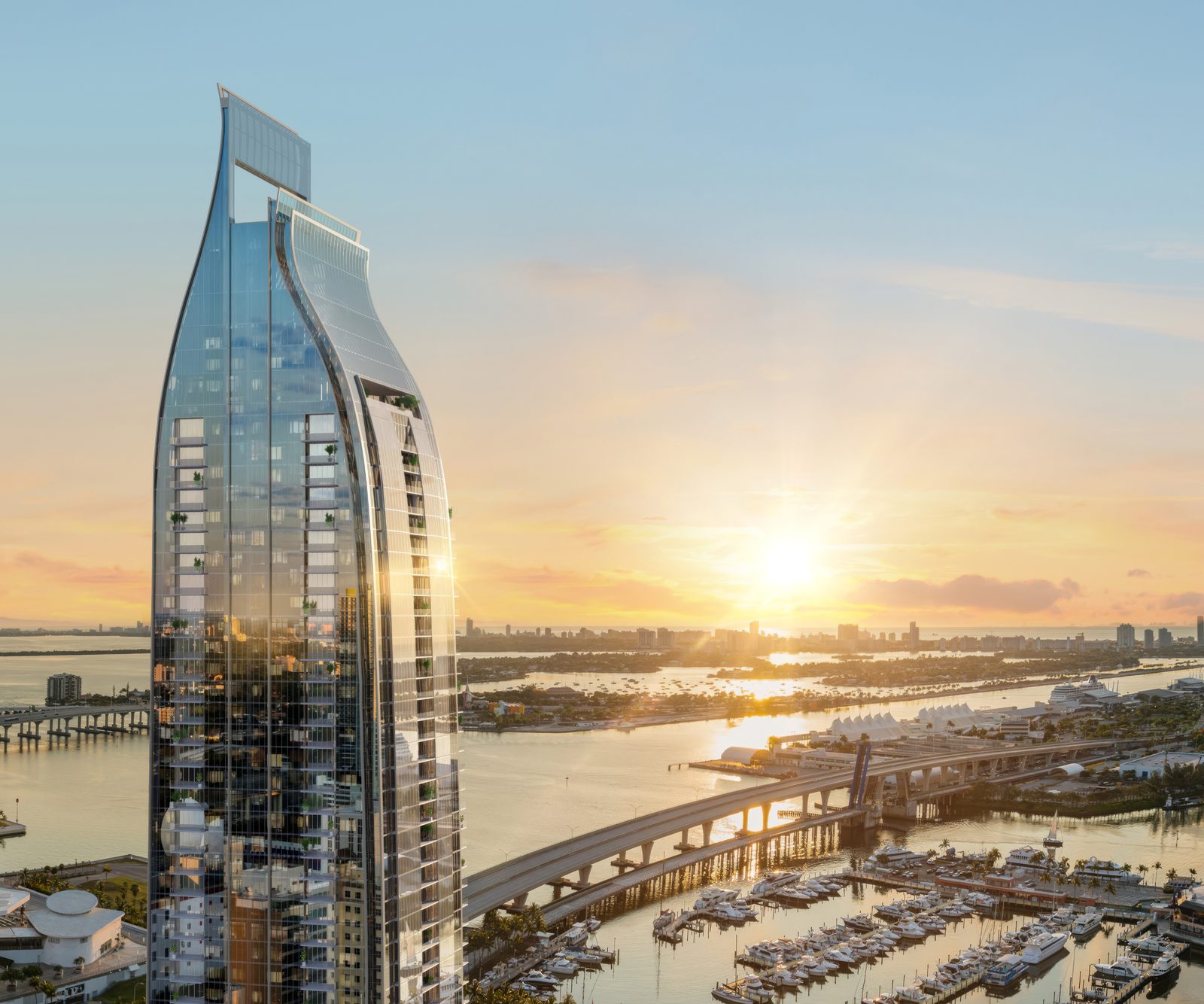 Rendering of Delano Residences and Hotel Miami, a slender glass tower with a curved crown over Biscayne Bay at sunset
