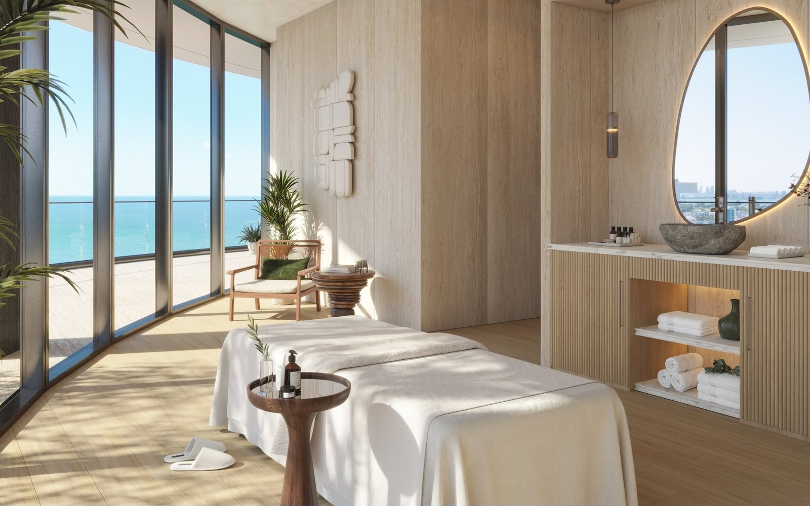 Render de la sala de terapia del Upper Penthouse con camilla y el océano tras el vidrio curvo