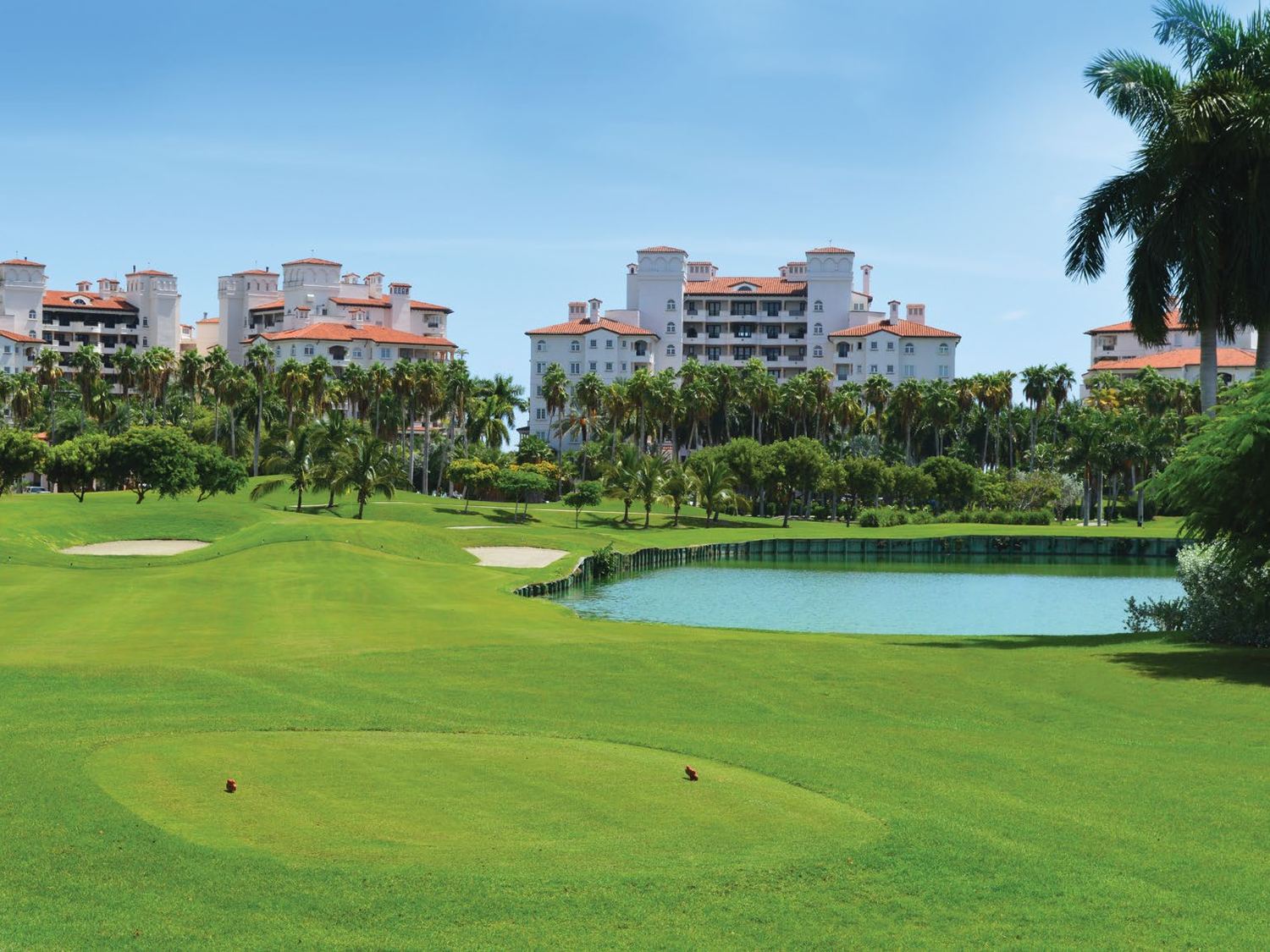 Photograph of the Fisher Island Club golf course with the Mediterranean buildings beyond